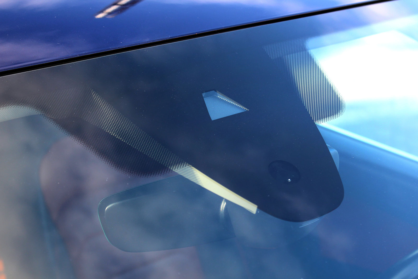 Forward-facing camera module mounted behind a windshield near the rear-view mirror