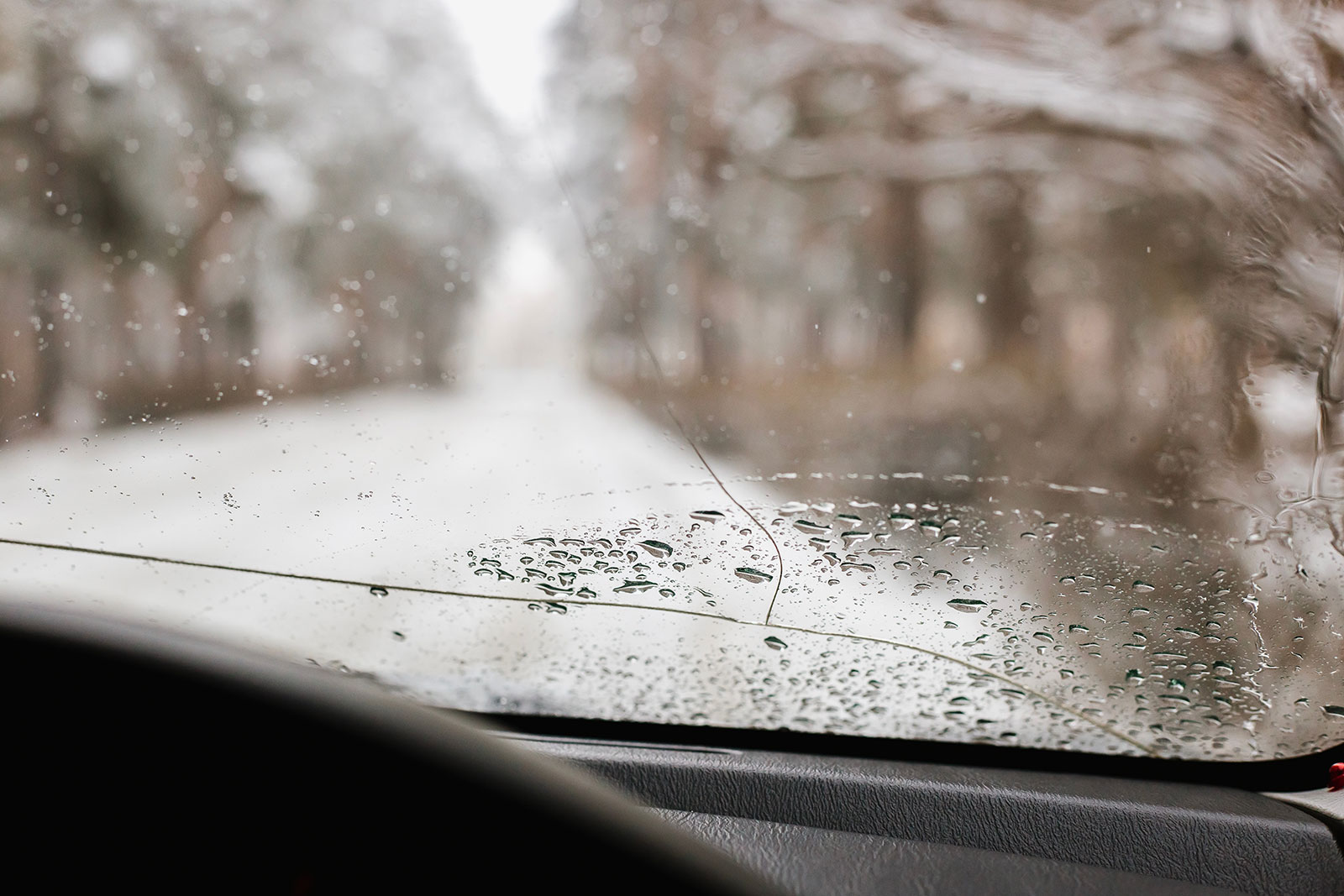 Frost-covered windshield with a crack running from a chip