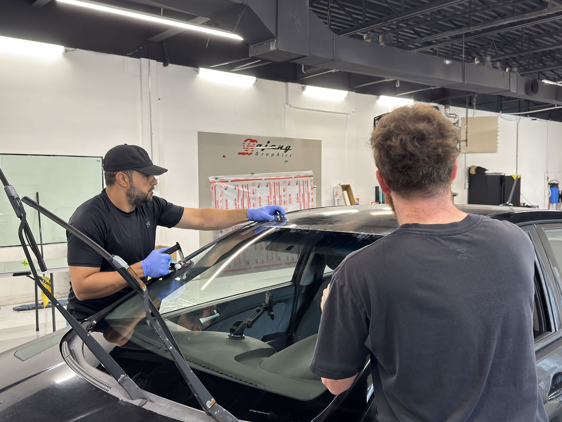 Fleet van windshield replacements at a customer's yard