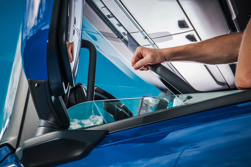 Replacement side mirror glass being fitted on a sedan