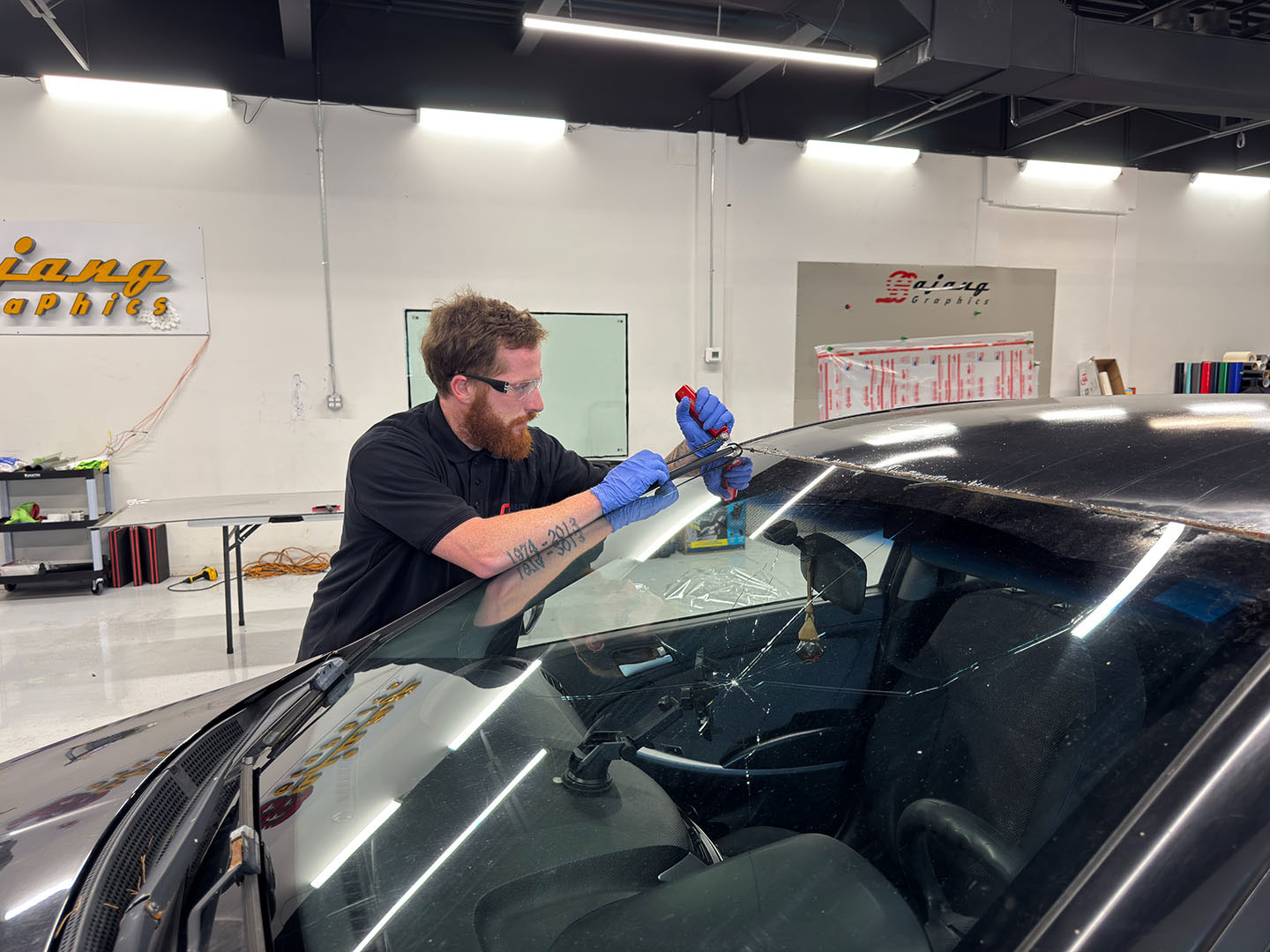 Technician setting a new windshield on a car at Ottawa Auto Glass